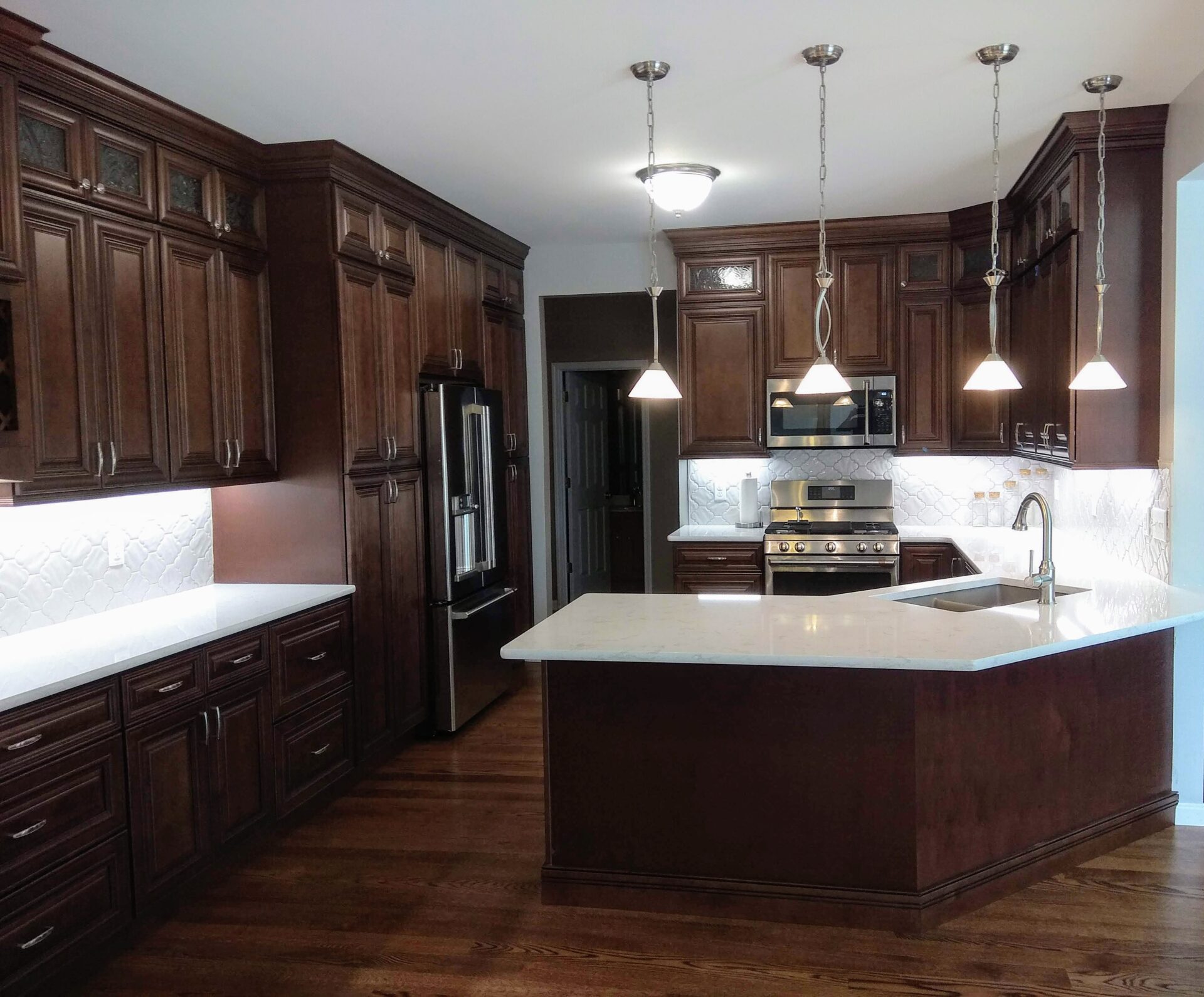 IMG_20191107_125959 an image of a modular kitchen with lights and chairs